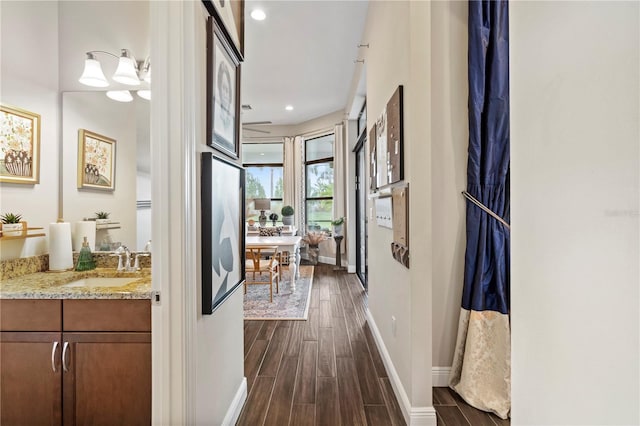 hallway featuring a chandelier and sink