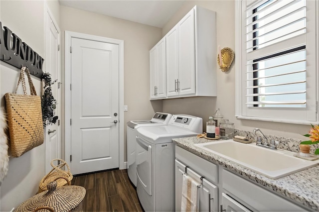 laundry room featuring cabinets, washing machine and dryer, and sink