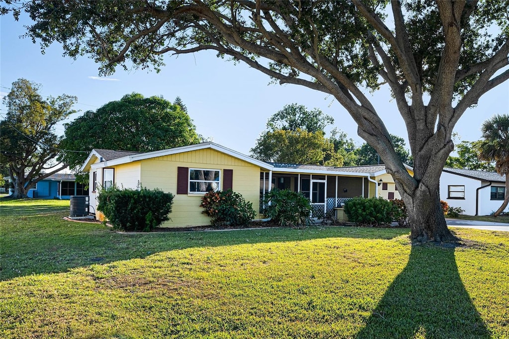 ranch-style home with a sunroom and a front yard