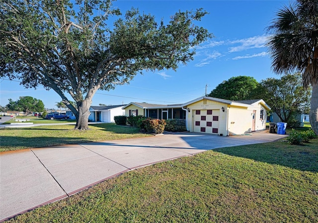 ranch-style house featuring a front yard and a garage