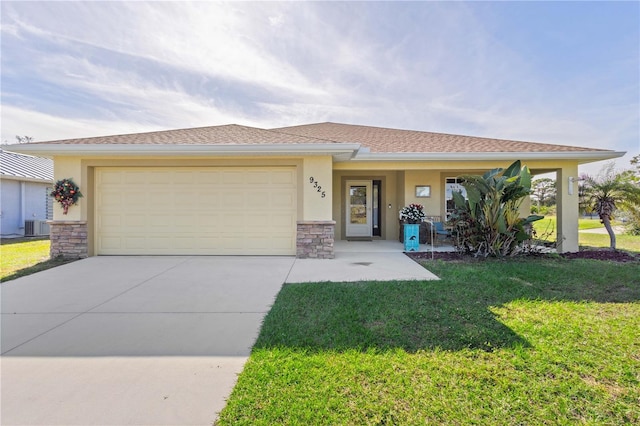 view of front of home with central air condition unit, a porch, a front yard, and a garage