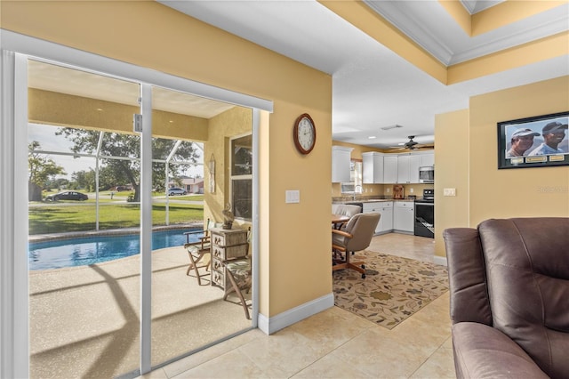 living room featuring light tile patterned floors, ceiling fan, and ornamental molding