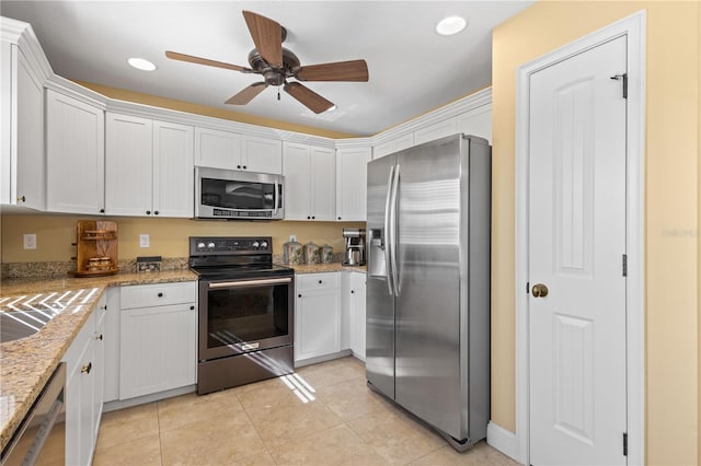 kitchen featuring white cabinets, appliances with stainless steel finishes, light tile patterned floors, and ceiling fan