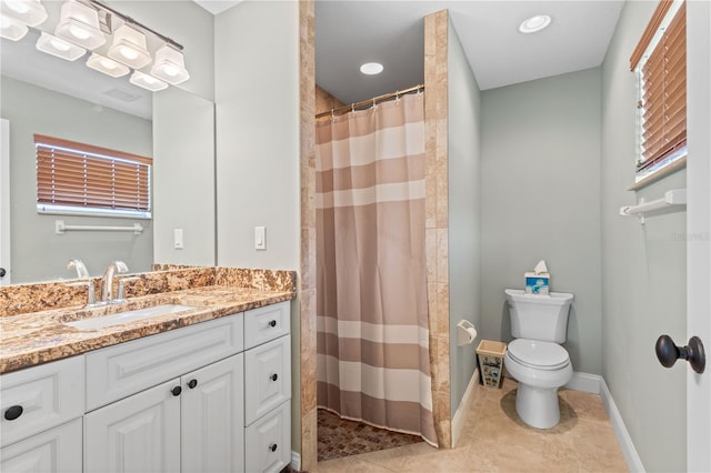 bathroom featuring vanity, curtained shower, and toilet