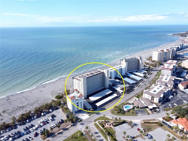 drone / aerial view with a water view and a view of the beach