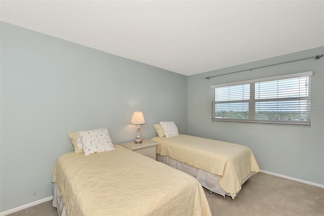 bedroom featuring light carpet