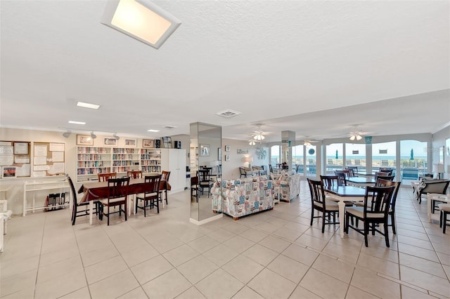 dining area featuring ceiling fan and light tile patterned floors