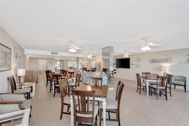 tiled dining room with a textured ceiling