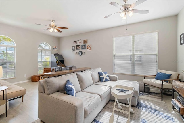 living room featuring ceiling fan and light wood-type flooring