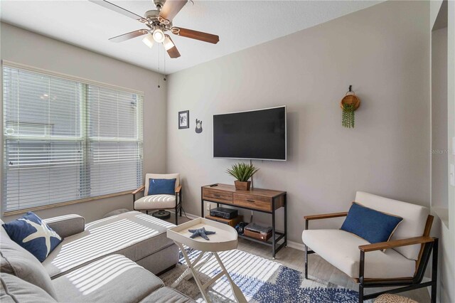 living room featuring ceiling fan and light wood-type flooring