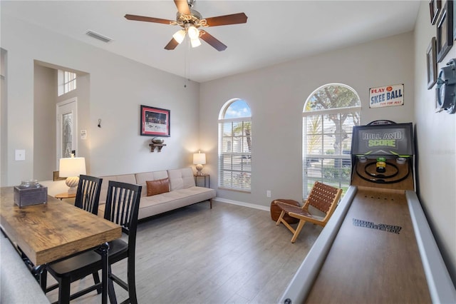 dining room with hardwood / wood-style floors and ceiling fan