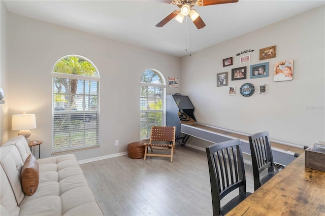 interior space featuring a crib, light hardwood / wood-style floors, and ceiling fan