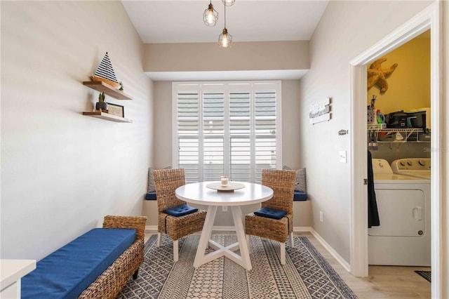 dining space featuring light hardwood / wood-style floors and washing machine and clothes dryer