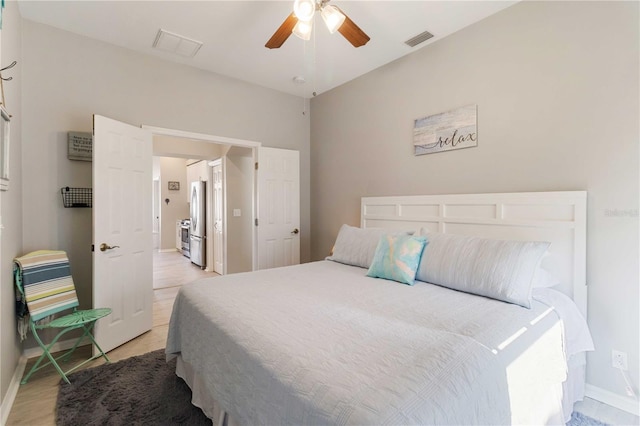 bedroom with ceiling fan and stainless steel fridge