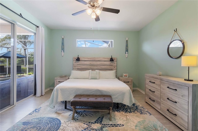 bedroom with ceiling fan, light hardwood / wood-style floors, access to outside, and multiple windows