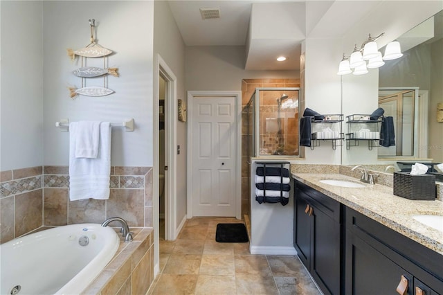 bathroom featuring vanity and shower with separate bathtub