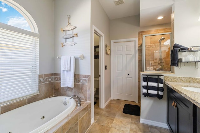 full bathroom featuring shower with separate bathtub, vanity, and toilet