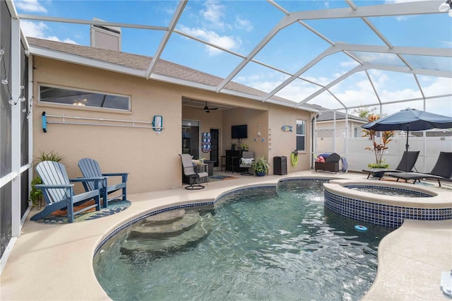 view of pool featuring a lanai, an in ground hot tub, ceiling fan, and a patio