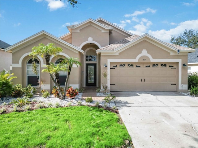 view of front of house featuring a front lawn and a garage