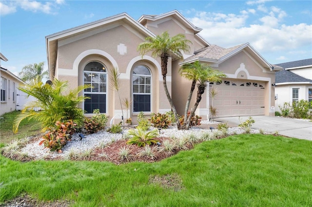 mediterranean / spanish-style home with a garage and a front yard