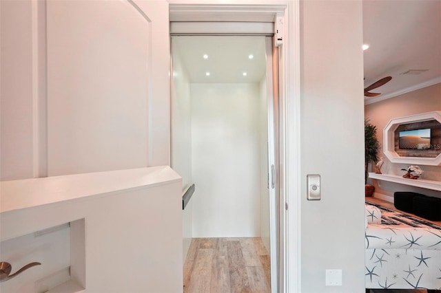 bathroom with ceiling fan, wood-type flooring, and crown molding