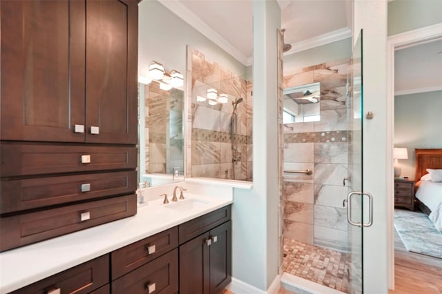 bathroom with ornamental molding, connected bathroom, vanity, and a shower stall