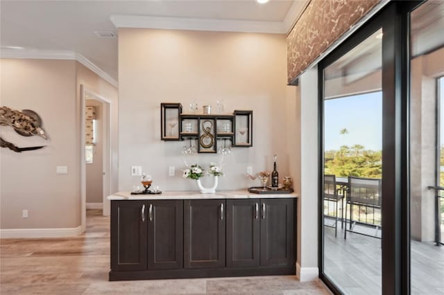 bar featuring light wood-type flooring, dark brown cabinets, and crown molding