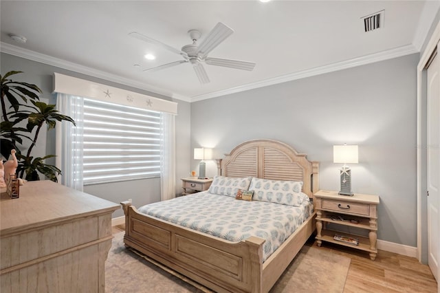 bedroom with light wood-type flooring, ceiling fan, and ornamental molding