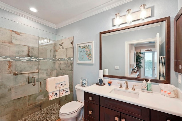 bathroom featuring ornamental molding, a shower stall, toilet, and vanity