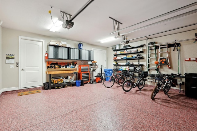 garage with baseboards and a garage door opener