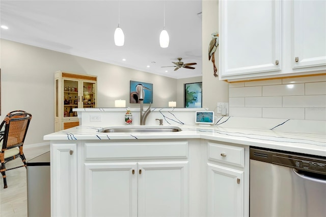 kitchen with ceiling fan, dishwasher, sink, decorative backsplash, and white cabinets