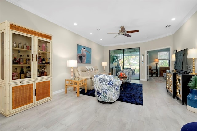 living room featuring ceiling fan and crown molding