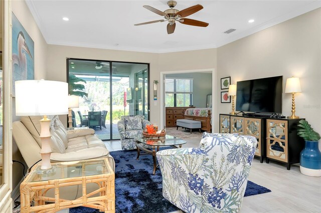 living room featuring ceiling fan and ornamental molding