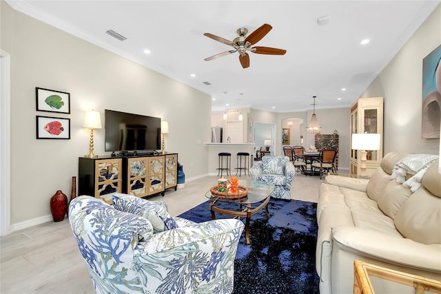 living room with ceiling fan and crown molding