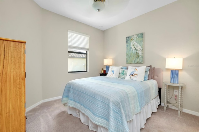 bedroom with ceiling fan and light colored carpet