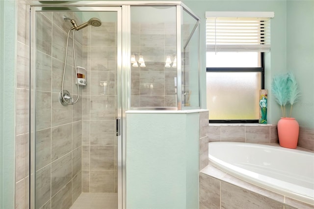 bathroom featuring shower with separate bathtub