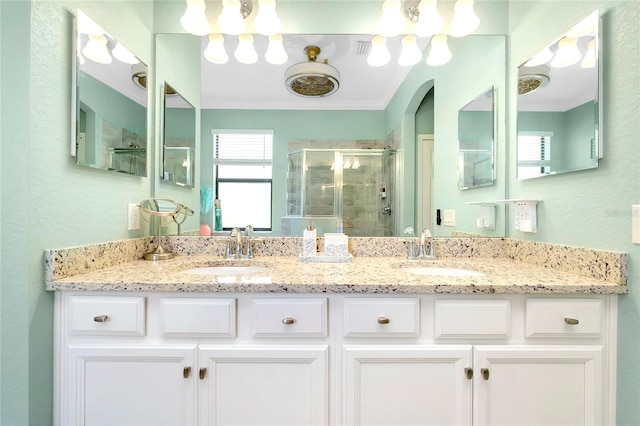 bathroom with vanity and a shower with door