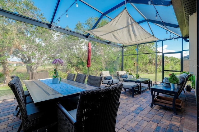 view of patio featuring glass enclosure and an outdoor hangout area