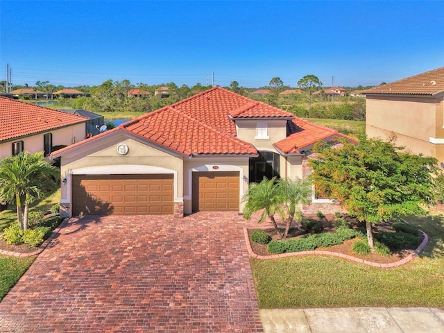 mediterranean / spanish-style house featuring a garage