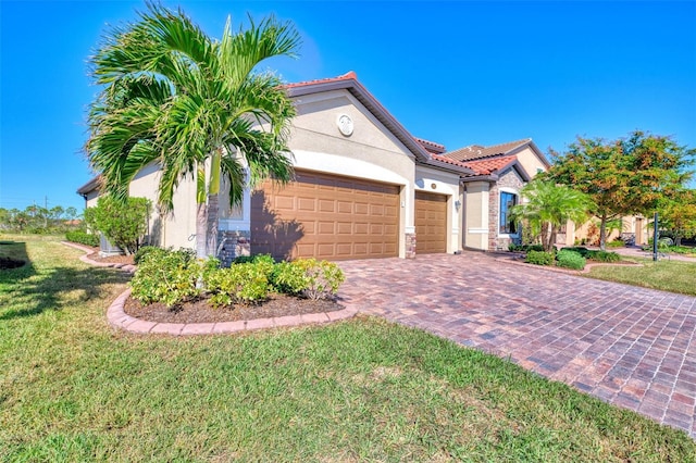 mediterranean / spanish home with a garage and a front lawn