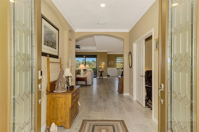 corridor featuring light tile patterned flooring and ornamental molding