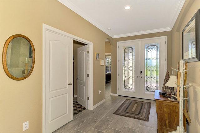 entrance foyer with ornamental molding and french doors