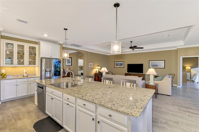 kitchen with pendant lighting, stainless steel appliances, ceiling fan, and sink