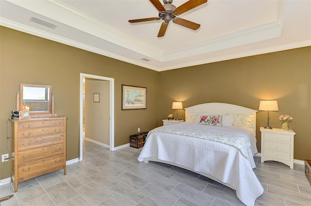 bedroom featuring a raised ceiling, ceiling fan, and crown molding