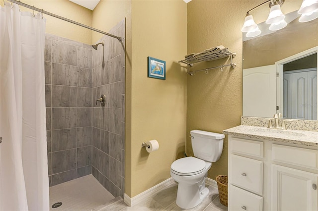 bathroom featuring tile patterned floors, curtained shower, vanity, and toilet