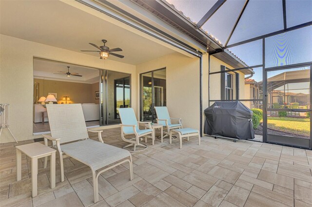 sunroom / solarium featuring ceiling fan