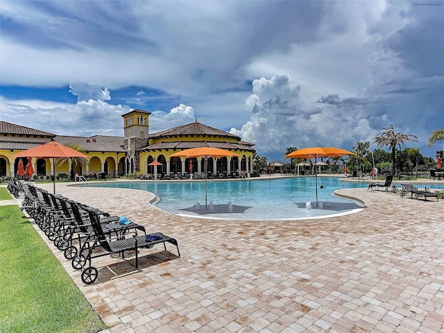 view of pool with pool water feature and a patio area