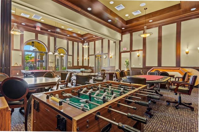 game room featuring carpet and a towering ceiling