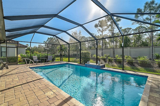 pool with a lanai and a patio area