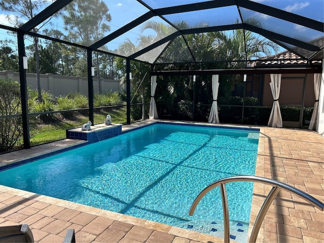 pool featuring a lanai and a patio area